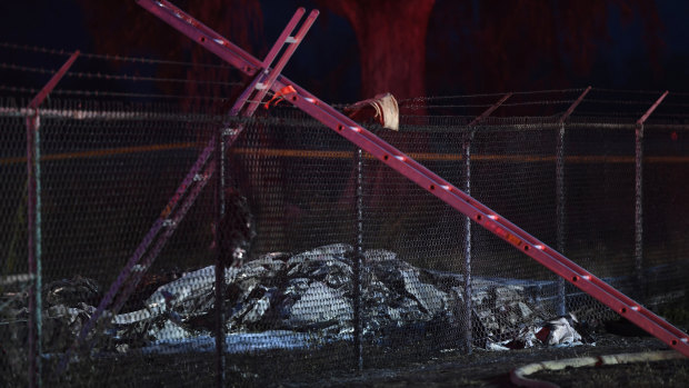 The remains of an aircraft that crashed carrying nine people lies on the ground at Dillingham Airfield.