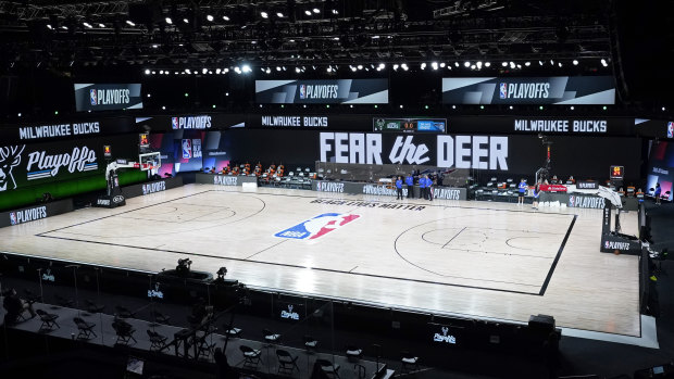 Officials stand beside an empty court after the scheduled start of game five between the Milwaukee Bucks and the Orlando Magic.  