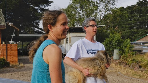 Plenty residents Ben, Lydia and their dog Eli prepare to evacuate their Mackelroy Road home ahead of a wind change.