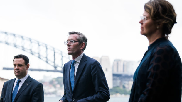 NSW Premier Dominic Perrottet (centre) with Tourism Minister Stuart Ayres and Susan Pearce from NSW Health at the announcement on Friday.
