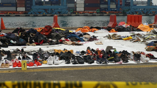 Debris and personal belongings fished out of the sea by search and rescue teams lined up at Tanjung Priok crisis centre.
