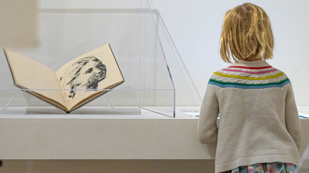 A girl observes part of the Picasso: 14 Sketchbooks exhibit at Pace Gallery in New York.