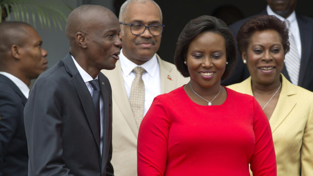 First lady Martine Moise, pictured in red, was also shot in the attack but survived. 