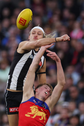 Collingwood skipper Darcy Moore spoils Brisbane’s Logan Morris.