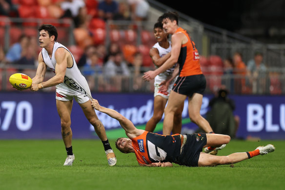 Zac Fisher of the Blues handpasses during the clash with Greater Western Sydney.