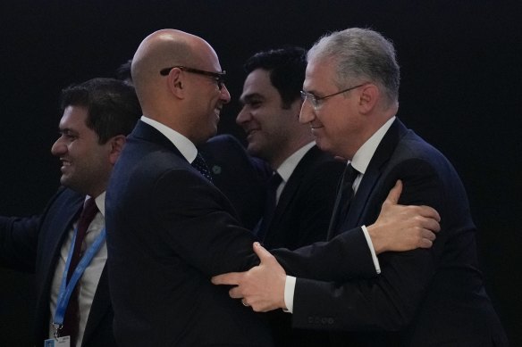 Mukhtar Babayev, COP29 president, right, embraces Simon Stiell, United Nations climate chief, after gaveling a deal for money to curb climate change.