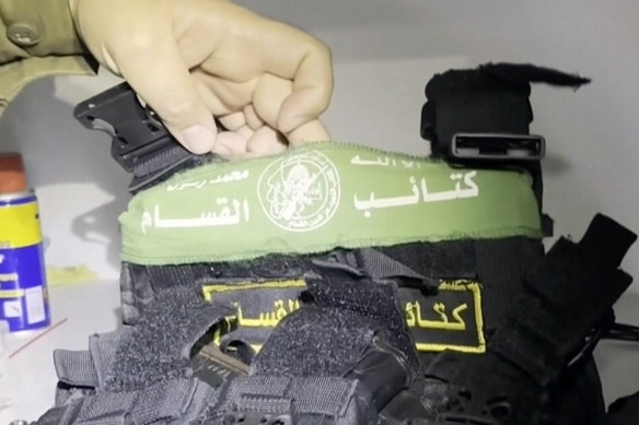 An Israeli military spokesman holds up a bulletproof vest with Hamas insignia the IDF says was found alongside weapons in a medical cupboard at the Al Shifa Hospital in Gaza City.