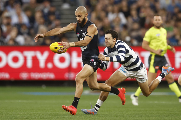 Adam Saad of the Blues kicks the ball whilst being tackled by Brad Close of the Cats.