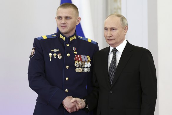 Russian President Vladimir Putin (right) with Sergeant Alexander Mikhailov during a ceremony to present Gold Star medals in the Grand Kremlin Palace in Moscow on Friday.