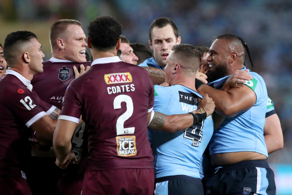 Maroon Lindsay Collins clashes with Blues forward Junior Paulo during game two of the State of Origin clash in Sydney on Wednesday night.