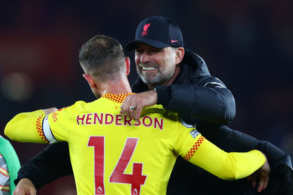 Liverpool manager Juergen Klopp and captain Jordan Henderson celebrate the Reds’ 2-1 win over Southampton.