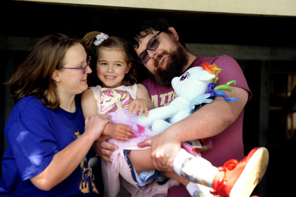 Violet Twomey, with her parents, Heather Mandy and Cristen Twomey, and Pegasus the pony.