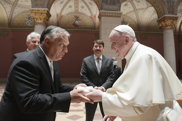 Pope Francis exchanges gifts with Hungarian Prime Minister Viktor Orban, at Budapest’s Museum of Fine Arts.