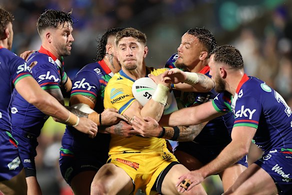 In a bind: Former Eels star Zac Lomax (centre) and Parramatta are heading to court.