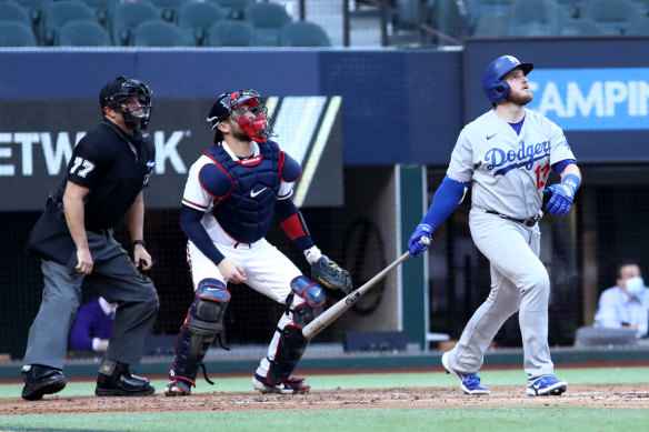 Max Muncy watches the ball leave the yard as his grand slam capped an 11-run first inning for the Dodgers.