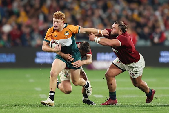 Tane Edmed of the AUNZ XV is tackled by Ben White 