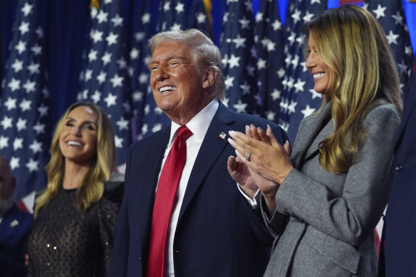 Donald Trump celebrates his victory flanked by daughter-in-law Lara Trump (left) and his wife, Melania.