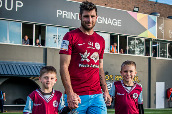 APIA Leichhardt striker Chris Payne with sons Cohen (left) and Cayde (right). 