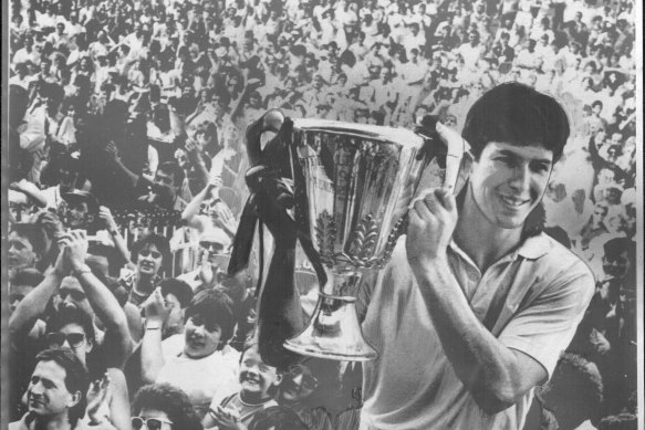 Stephen Kernahan, pictured holding the  1987 premiership cup, is happy to see Joel Selwood equal his record. 