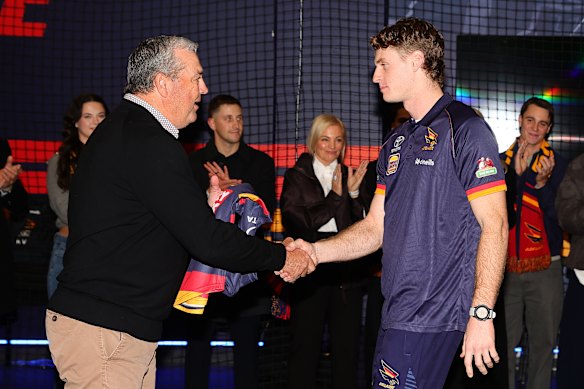 Hugo Hall-Kahan being presented his jumper by Bruce Linder.
