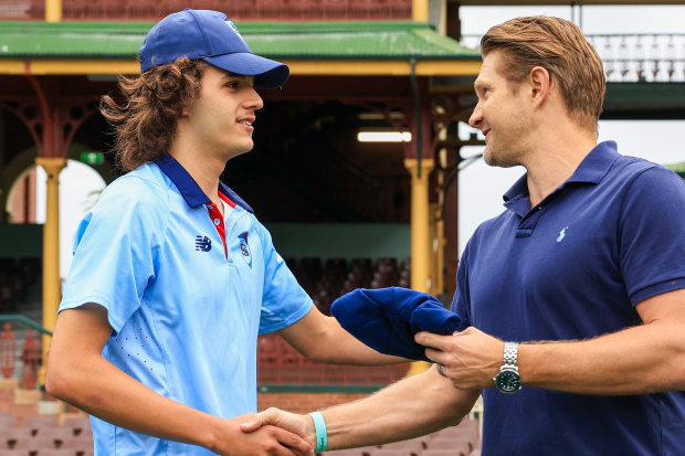 Partnership: Sam Konstas receives his NSW cap before his Shield debut last year.