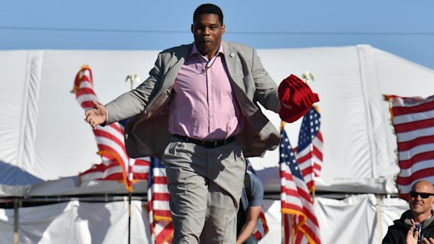Herschel Walker, who is running for the Republican nomination to US Senate, takes on the stage during a rally for Georgia GOP candidates in March.