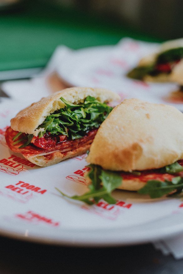 A house-baked puccia with hot salami, provolone, semi-dried tomatoes, rocket and chilli at Tooradeli.