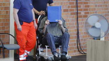 The accused Josef S covers his face as he sits at the court room in Brandenburg, Germany on Tuesday.