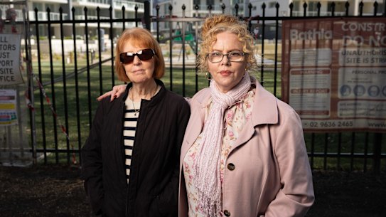Sue Mancuso and daughter Marie Sinclair stand in front of the fenced-off Kembla Grange development.