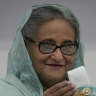 Bangladesh Prime Minister Sheikh Hasina shows her ballot paper as she casts her vote.