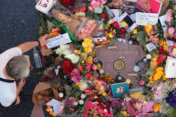 Flowers, notes and photos are left on Dolly Parton’s star on the Hollywood Walk of Fame.
