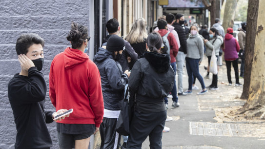 People outside a Sydney Centrelink office earlier this year after new lockdowns hit the city. UNSW research shows many will take a hit to their finances as assistance is cut by the federal government.