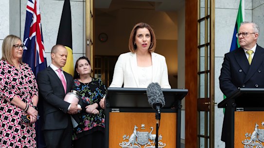 Parents Mia Bannister (left), Robb Evans and Emma Mason with Communications Minister Anika Wells and Anthony Albanese at a press conference at Parliament House in Canberra on Wednesday.