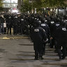 New York police officers move towards an entrance to Columbia University.
