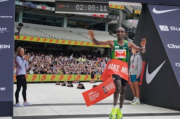 Eliud Kipchoge, winner and record breaker of the men’s Melbourne Marathon, crosses the finish line at the MCG. in Melbourne