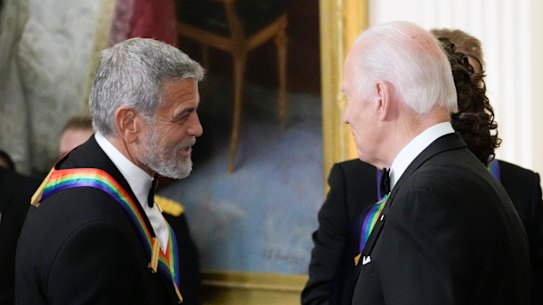 President Joe Biden shakes hands with George Clooney during the Kennedy Centre honourees reception at the White House in Washington, December 2022.