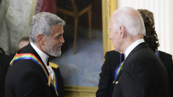President Joe Biden shakes hands with George Clooney during the Kennedy Centre honourees reception at the White House in Washington, December 2022.