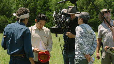 Lachlan Milne prepares to shoot a scene with Steven Yeun (second from left) in farmland in Tulsa, Oklahoma.