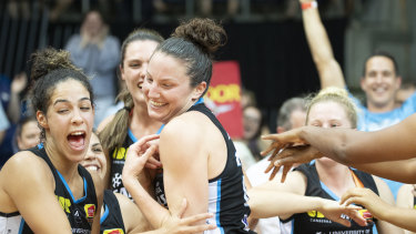 Canberra Capitals teammates cheer their co-captain Kelsey Griffin
