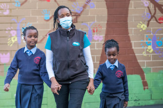 Rehab Chege with her two daughters arriving for school earlier this morning in Melbourne’s north-western suburbs.  