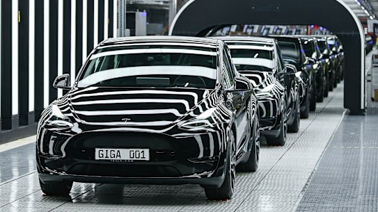 Model Y electric vehicles stand on a conveyor belt at the opening of the Tesla factory in Berlin Brandenburg in Gruenheide, Germany, in March. 