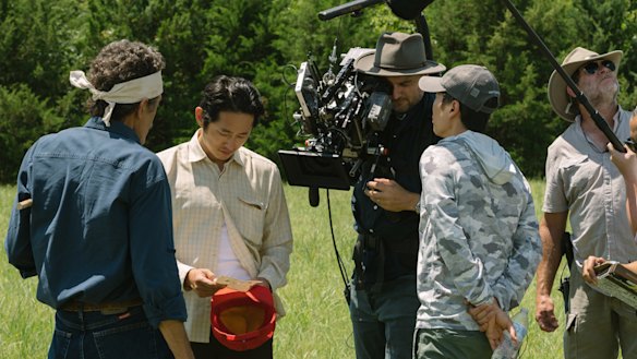 Lachlan Milne prepares to shoot a scene with Steven Yeun (second from left) in farmland in Tulsa, Oklahoma.