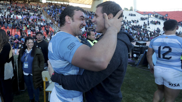 All smiles: Argentina's Agustin Creevy (left) embraces assistant coach Gonzalo Quesada after beating South Africa.