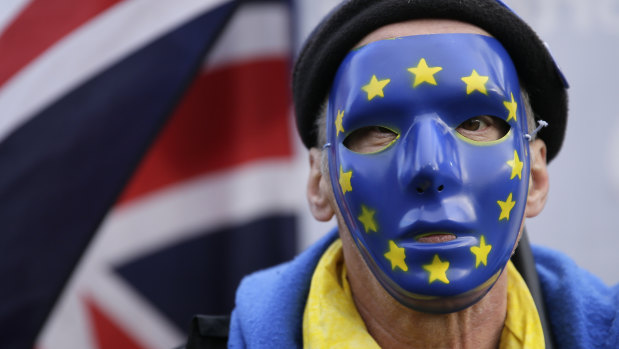 An anti-Brexit demonstrator wears a mask bearing stars of the European flag, during a protest outside the houses of Parliament in London last month.