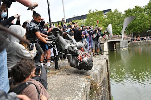 Protesters throwing a statue of slave trader Edward Colston into Bristol Harbour on June 7.