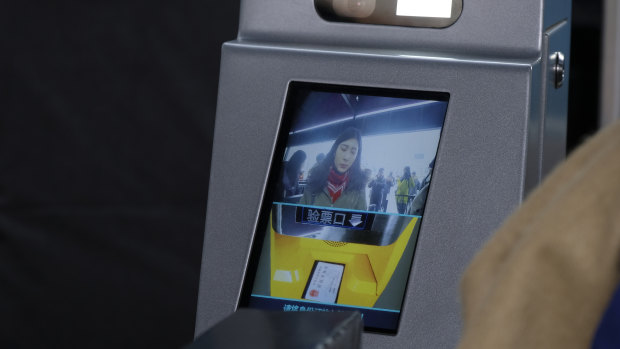 Facial recognition technology at a train station in China, where commuters are scored on their behaviour for a national "social credit" system.