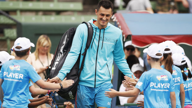 Bernard Tomic eased into the Australian summer of tennis with a win at Kooyong on Monday.