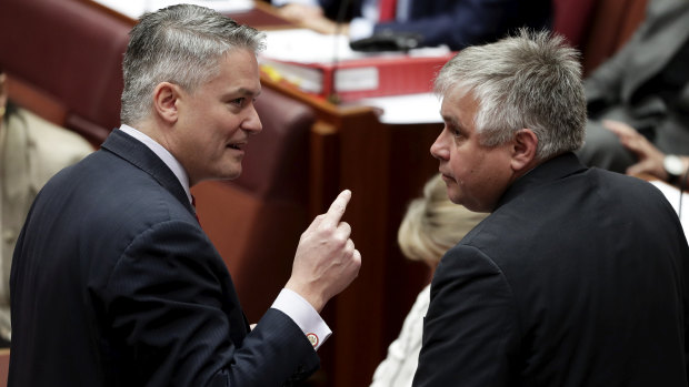 Minister for Finance Mathias Cormann in discussion with senator Rex Patrick in the Senate. 