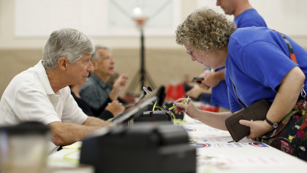 Voters sign in to cast their ballots in a polling station in Westerville, Ohio.  
