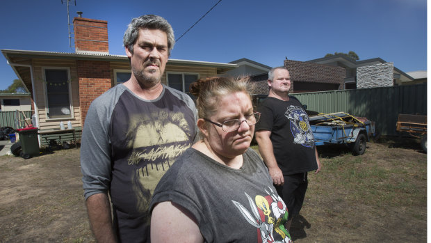 From left: Ronald Lyons, Christine Lyons and Peter Arthur outside their home in the days after Samantha Kelly went missing.
